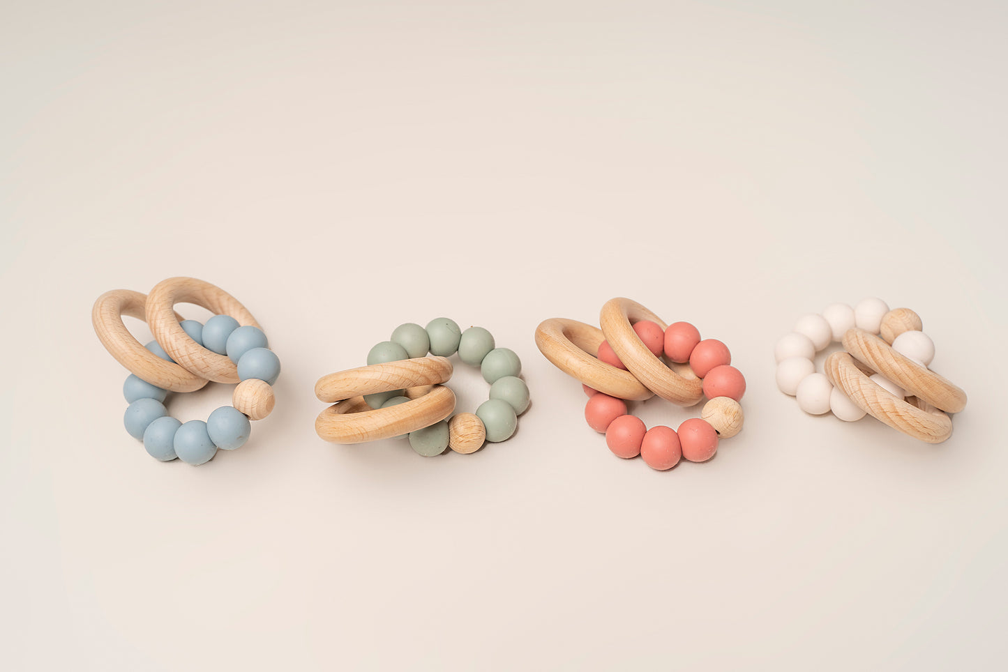 Teething Rings featuring natural wood and soft silicone for a soothing and safe teething experience. These rings have a dual-texture, easy-to-grasp design and non-toxic materials for your baby's comfort and relief. Portable and easy to clean, making teething on-the-go a breeze. Available in 4 colors, crafted with premium food-grade silicone for safety and durability.
