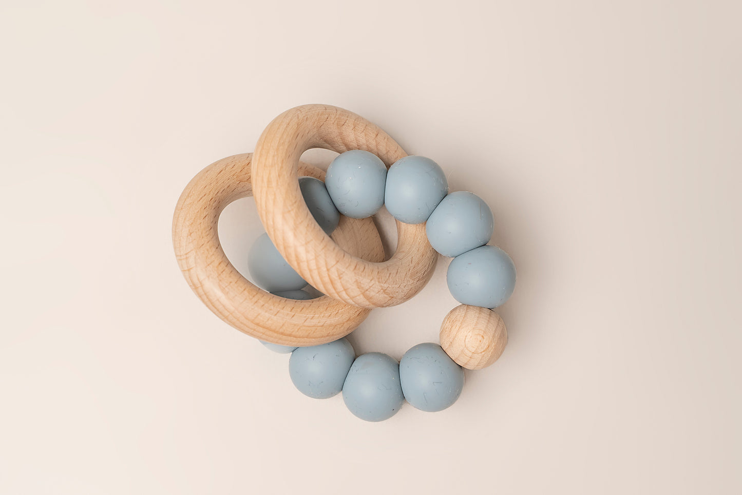 Teething Rings featuring natural wood and soft silicone for a soothing and safe teething experience. These rings have a dual-texture, easy-to-grasp design and non-toxic materials for your baby's comfort and relief. Portable and easy to clean, making teething on-the-go a breeze. Available in 4 colors, crafted with premium food-grade silicone for safety and durability.