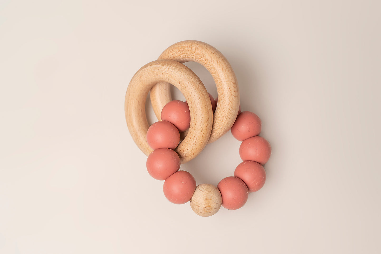 Teething Rings featuring natural wood and soft silicone for a soothing and safe teething experience. These rings have a dual-texture, easy-to-grasp design and non-toxic materials for your baby's comfort and relief. Portable and easy to clean, making teething on-the-go a breeze. Available in 4 colors, crafted with premium food-grade silicone for safety and durability.