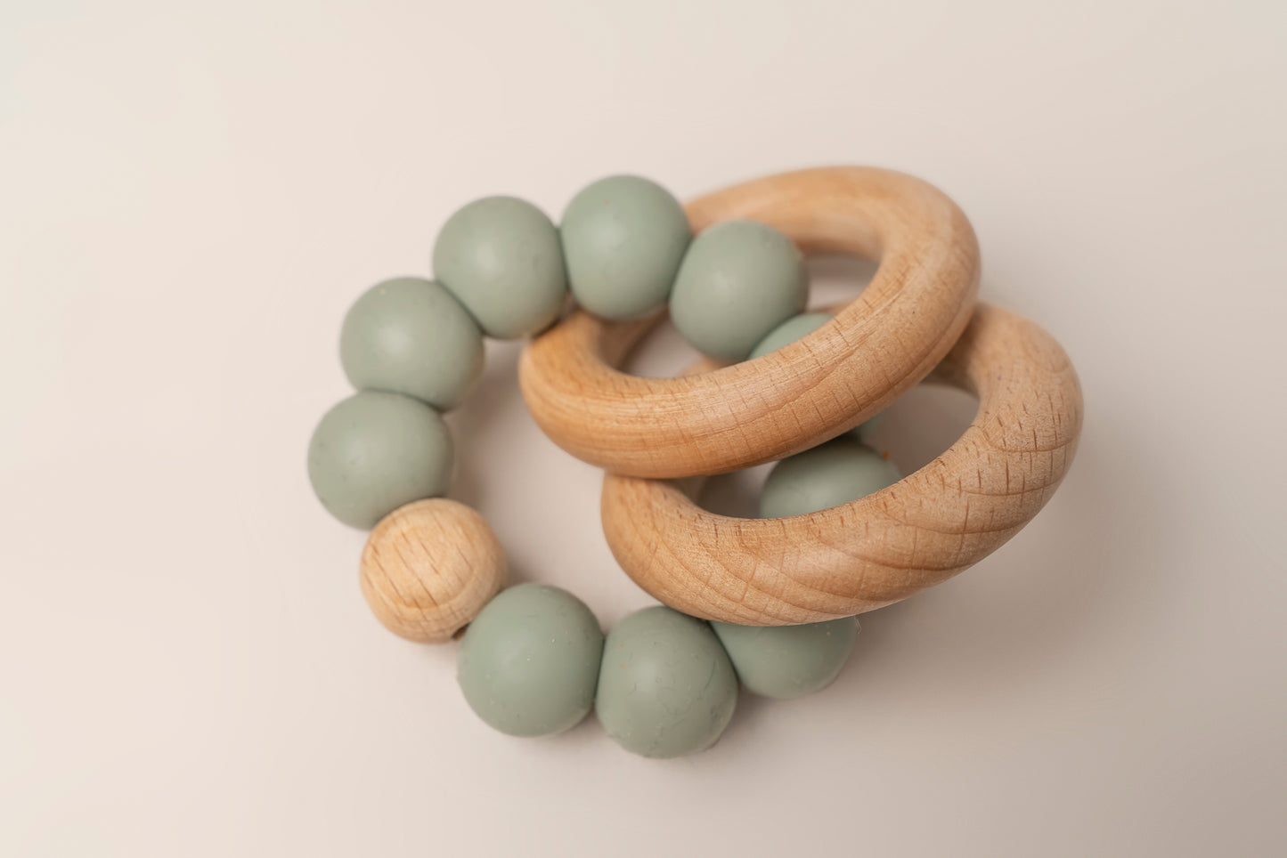 Teething Rings featuring natural wood and soft silicone for a soothing and safe teething experience. These rings have a dual-texture, easy-to-grasp design and non-toxic materials for your baby's comfort and relief. Portable and easy to clean, making teething on-the-go a breeze. Available in 4 colors, crafted with premium food-grade silicone for safety and durability.