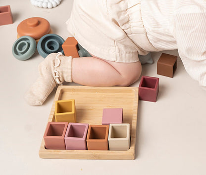 Sort & Stack Blocks for babies and toddlers, designed to spark creativity and learning. These blocks offer colour sorting, stacking, fine motor skill development, and hand-eye coordination. Easy-to-grasp for independent play and exploration. Made from food-grade silicone with a natural wood holder, these blocks are easy to clean, durable, and free from harmful chemicals, safe for teething babies. A playtime essential for every Mini!