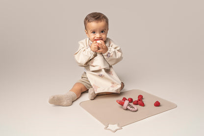 A premium, non-toxic, food-grade silicone feeding tool designed for introducing fruits and vegetables to your baby. It features an easy-grip handle for independent exploration and a silicone mesh pouch to safely hold small food pieces, preventing choking hazards. This feeder promotes healthy eating habits, self-feeding skills, and is also suitable for teething relief. BPA and phthalate-free, with unbreakable construction, waterproof, easy to clean, and safe for microwave and dishwasher use.