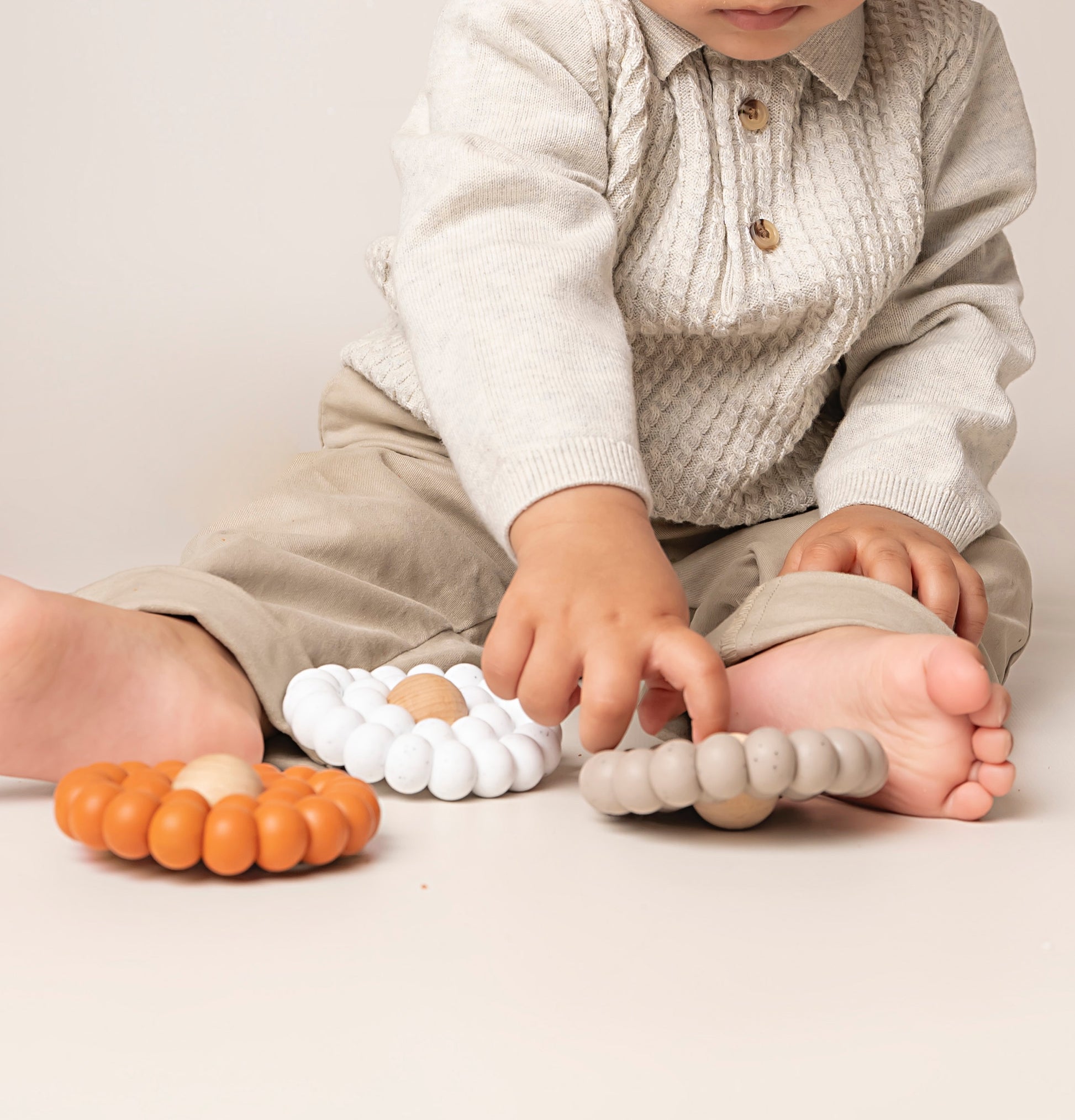A Teething toy for babies made up of many large silicone beads to mimic a flower. A stylish and soothing solution for infants. Available in 4 colours, it is carefully crafted with premium food-grade silicone for safety and durability.