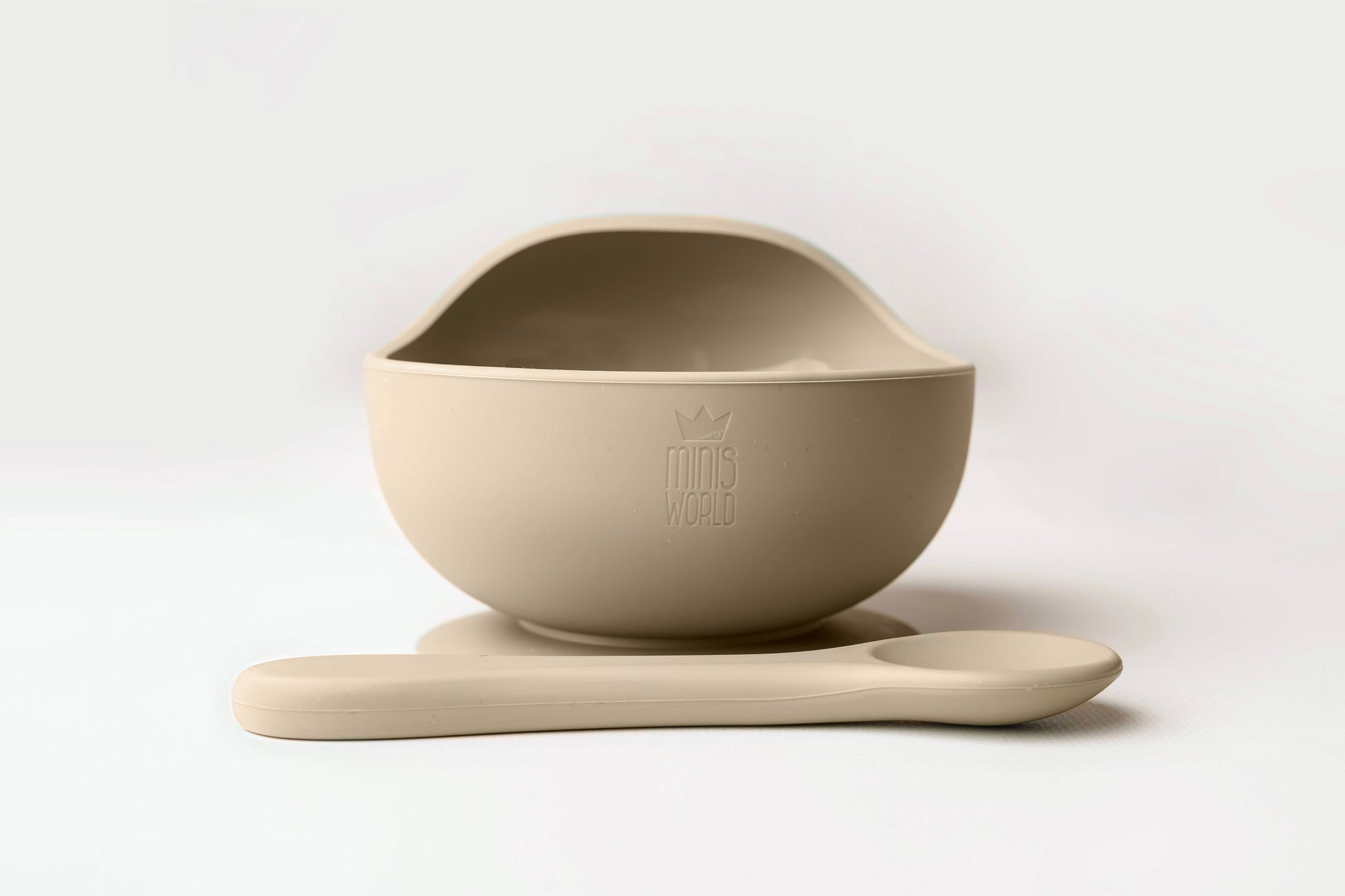 A baby weaning Suction Bowl + Spoon Set designed to make weaning easier and help babies and toddlers establish mealtime independence. The set features a raised side to assist child in scooping up food independently. It has a strong suction base to prevent spills and overturned bowls. Made from BPA and Phthalate-free, non-toxic food-grade silicone, it is unbreakable, waterproof, and easy to clean. Microwave and dishwasher safe.