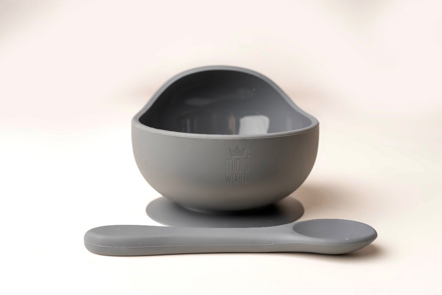A baby weaning Suction Bowl + Spoon Set designed to make weaning easier and help babies and toddlers establish mealtime independence. The set features a raised side to assist child in scooping up food independently. It has a strong suction base to prevent spills and overturned bowls. Made from BPA and Phthalate-free, non-toxic food-grade silicone, it is unbreakable, waterproof, and easy to clean. Microwave and dishwasher safe.