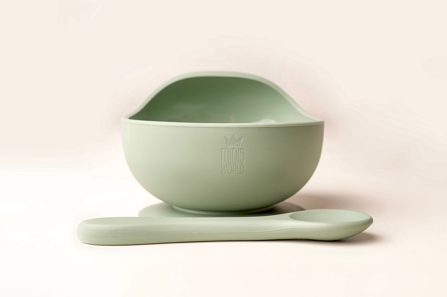 A baby weaning Suction Bowl + Spoon Set designed to make weaning easier and help babies and toddlers establish mealtime independence. The set features a raised side to assist child in scooping up food independently. It has a strong suction base to prevent spills and overturned bowls. Made from BPA and Phthalate-free, non-toxic food-grade silicone, it is unbreakable, waterproof, and easy to clean. Microwave and dishwasher safe.