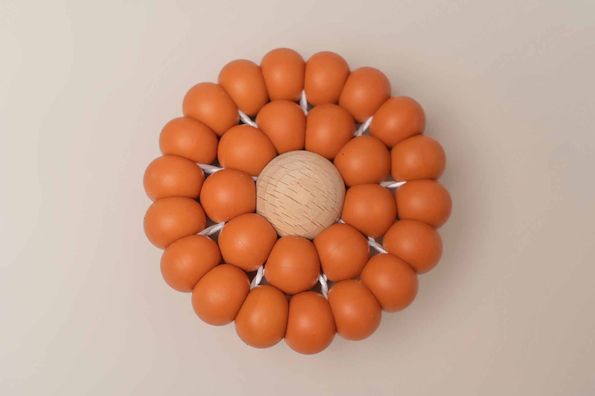 A Teething toy for babies made up of many large silicone beads to mimic a flower. A stylish and soothing solution for infants. Available in 4 colours, it is carefully crafted with premium food-grade silicone for safety and durability.